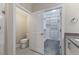 This bathroom has a toilet, quartz countertops, tile floors, and closet access at 705 Churton Pl, Cary, NC 27518