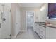This bathroom has double sinks, quartz countertops, shower, tile floors, and closet access at 705 Churton Pl, Cary, NC 27518