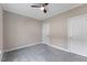 Neutral bedroom featuring gray carpet, a ceiling fan, closet and doors at 705 Churton Pl, Cary, NC 27518