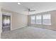 Bright bedroom with plush carpet, ceiling fan, and three windows offering natural light, creating a serene atmosphere at 705 Churton Pl, Cary, NC 27518