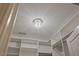 This walk-in closet has a decorative light fixture, built-in shelves, and hanging rods at 705 Churton Pl, Cary, NC 27518
