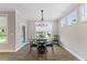 Dining room with chandelier, table, 4 chairs, and many windows at 705 Churton Pl, Cary, NC 27518