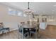 Dining room features a wood table, four chairs, and a modern chandelier at 705 Churton Pl, Cary, NC 27518
