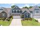 Charming two-story home with a stone facade, gray siding, and a neatly landscaped front yard at 705 Churton Pl, Cary, NC 27518