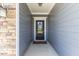 Stylish front door with glass pane and a 'welcome' mat leading into the home at 705 Churton Pl, Cary, NC 27518