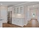 Bright kitchen features stainless steel refrigerator, granite counters, and white cabinets at 705 Churton Pl, Cary, NC 27518