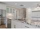 Bright kitchen features stainless appliances, granite counters, and island with sink at 705 Churton Pl, Cary, NC 27518