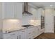 Bright kitchen features stainless appliances, granite counters, and white cabinets at 705 Churton Pl, Cary, NC 27518