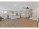Bright, open-concept living area flowing into the kitchen, featuring wood floors and ample lighting at 705 Churton Pl, Cary, NC 27518