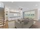 Inviting living area with stylish decor, wood floors, built-in shelving, and ample lighting at 705 Churton Pl, Cary, NC 27518