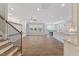 Bright open-concept living space with wood flooring, large windows, and modern decor at 705 Churton Pl, Cary, NC 27518