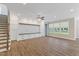 Living room showcasing wood flooring, built-ins, and large windows at 705 Churton Pl, Cary, NC 27518