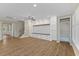 Open-concept living space showcasing wood flooring, built-ins, and large windows at 705 Churton Pl, Cary, NC 27518