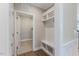Functional mudroom with a built-in bench, hooks, and storage, adjacent to the laundry room at 705 Churton Pl, Cary, NC 27518