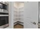 A large walk-in pantry with white shelves offers great storage and organization at 705 Churton Pl, Cary, NC 27518