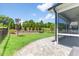 Stone patio leads to a screened porch with views of a professionally landscaped yard with black fence at 705 Churton Pl, Cary, NC 27518