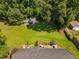 Aerial view of home with a large, tree-lined backyard, featuring a patio area, outbuildings, and a well-kept lawn at 73 Richmond Dr, Archer Lodge, NC 27527