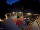 Back deck with outdoor seating, a beautiful flower arrangement and solar lighting at night at 73 Richmond Dr, Archer Lodge, NC 27527