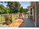 Back deck with outdoor seating, a beautiful flower arrangement and view of the backyard with a fire pit at 73 Richmond Dr, Archer Lodge, NC 27527