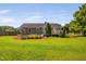 Well-maintained backyard featuring a patio with a fire pit, a covered bar, and lush green grass at 73 Richmond Dr, Archer Lodge, NC 27527