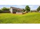 A section of the backyard features a covered bar, a fire pit area, and a grassy lawn at 73 Richmond Dr, Archer Lodge, NC 27527