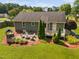 Aerial view of backyard with a fire pit, covered bar, well-manicured lawn, and a deck area off the house at 73 Richmond Dr, Archer Lodge, NC 27527