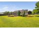 Expansive backyard view showcases a well-kept lawn, inviting patio with a fire pit, and a charming covered bar area at 73 Richmond Dr, Archer Lodge, NC 27527