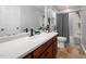 Bathroom featuring a single sink vanity with a black faucet, toilet, and tub with grey chevron curtain at 73 Richmond Dr, Archer Lodge, NC 27527