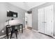 Bedroom with TV, work desk and chair, closet and a window with grey curtains at 73 Richmond Dr, Archer Lodge, NC 27527