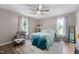 Bedroom featuring large windows, ceiling fan, and neutral colors at 73 Richmond Dr, Archer Lodge, NC 27527