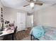 Bedroom with ceiling fan, work desk and chair, double closets, a bed with blue blanket and wood-look flooring at 73 Richmond Dr, Archer Lodge, NC 27527