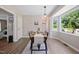 Dining area featuring a large window, modern light fixture, and seating for six at 73 Richmond Dr, Archer Lodge, NC 27527