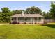 Charming ranch-style home featuring a welcoming front porch, tidy landscaping, and a lush green lawn at 73 Richmond Dr, Archer Lodge, NC 27527