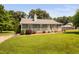 Beautiful ranch-style home boasts a well-manicured lawn, a front porch, and mature trees at 73 Richmond Dr, Archer Lodge, NC 27527