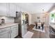 Modern kitchen featuring stainless steel appliances, adjacent to the dining area and a view of the front at 73 Richmond Dr, Archer Lodge, NC 27527