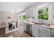 Kitchen with stainless steel appliances, white subway tile backsplash, and a view of the dining area at 73 Richmond Dr, Archer Lodge, NC 27527