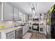 Bright kitchen featuring white cabinets, stainless appliances, and granite countertops at 73 Richmond Dr, Archer Lodge, NC 27527