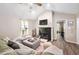 Bright living room featuring a fireplace, comfortable sofa, and open layout at 73 Richmond Dr, Archer Lodge, NC 27527