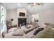 Cozy living room with a fireplace, ceiling fan, and comfortable seating at 73 Richmond Dr, Archer Lodge, NC 27527