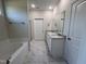 Bright bathroom with double vanity, granite countertop, tile flooring, and a separate tub and shower at 78 Mineral Springs Way, Benson, NC 27504
