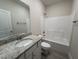 Bathroom with granite countertop, white cabinets, and a shower-tub combo at 78 Mineral Springs Way, Benson, NC 27504