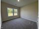 Bedroom featuring neutral walls, plush carpeting, and a scenic view at 78 Mineral Springs Way, Benson, NC 27504