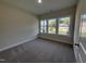 Bedroom with neutral walls, plush carpeting, and a view of the neighborhood at 78 Mineral Springs Way, Benson, NC 27504