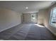 Bonus room with plush carpeting, neutral walls, and plenty of natural light from large windows at 78 Mineral Springs Way, Benson, NC 27504