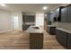 Modern kitchen features an island, gray cabinetry and granite countertops at 78 Mineral Springs Way, Benson, NC 27504