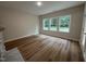 Sunlit living room with wood flooring, windows and natural light at 78 Mineral Springs Way, Benson, NC 27504