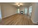 Spacious living room boasts wood flooring, a ceiling fan and a charming fireplace at 78 Mineral Springs Way, Benson, NC 27504