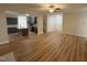 Open floor plan living room with wood floors connects to the kitchen with an island and staircase at 78 Mineral Springs Way, Benson, NC 27504