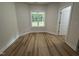 Cozy room with wood flooring and a window overlooking the backyard at 78 Mineral Springs Way, Benson, NC 27504