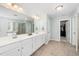 Bright bathroom featuring a double vanity, tiled floor, walk-in closet, and separate shower and bathtub at 78 N Porcenna Ln, Clayton, NC 27527